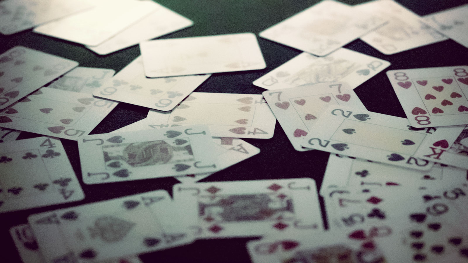 cards spread all over poker carpet at cpc